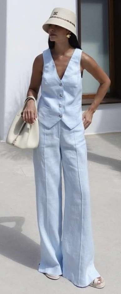 Pale blue linen vest and wide-leg trousers with a straw hat