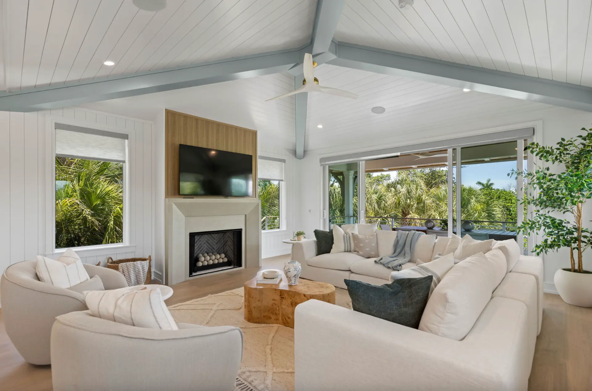 Bright vaulted living room of the island house, opening to the terrace and palms