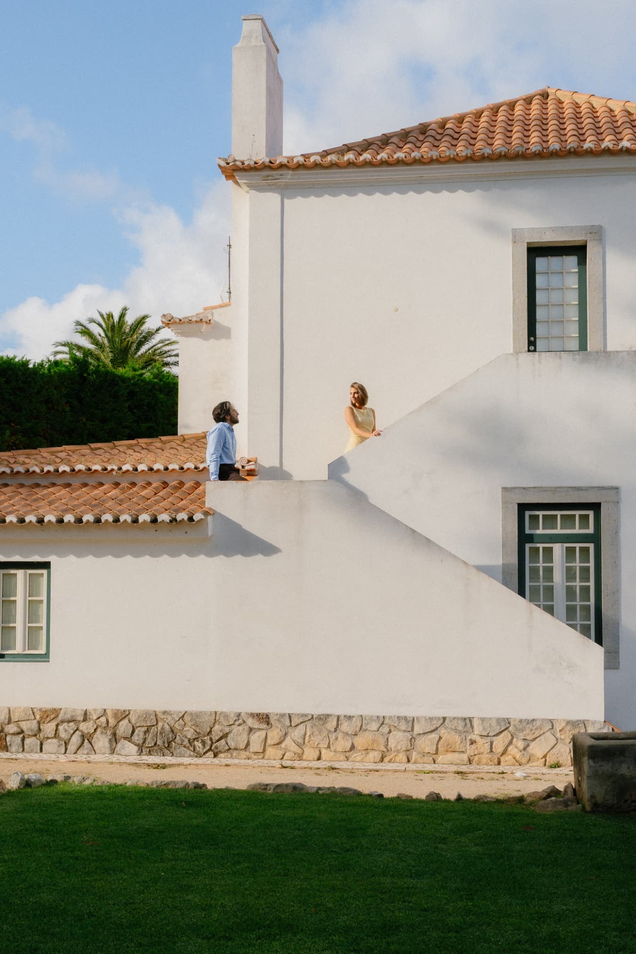 Kayla and Bruno on the white staircase of a Portuguese villa