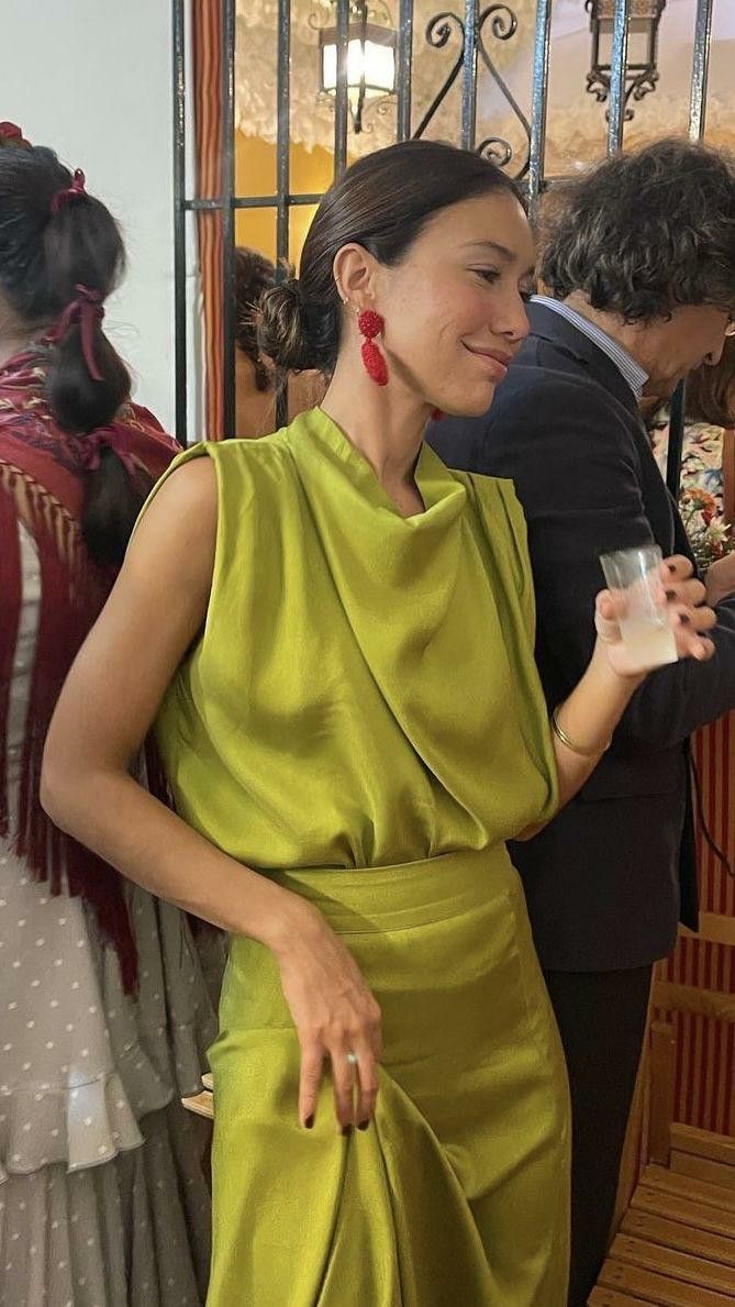 Guest in an olive silk column dress at a wedding