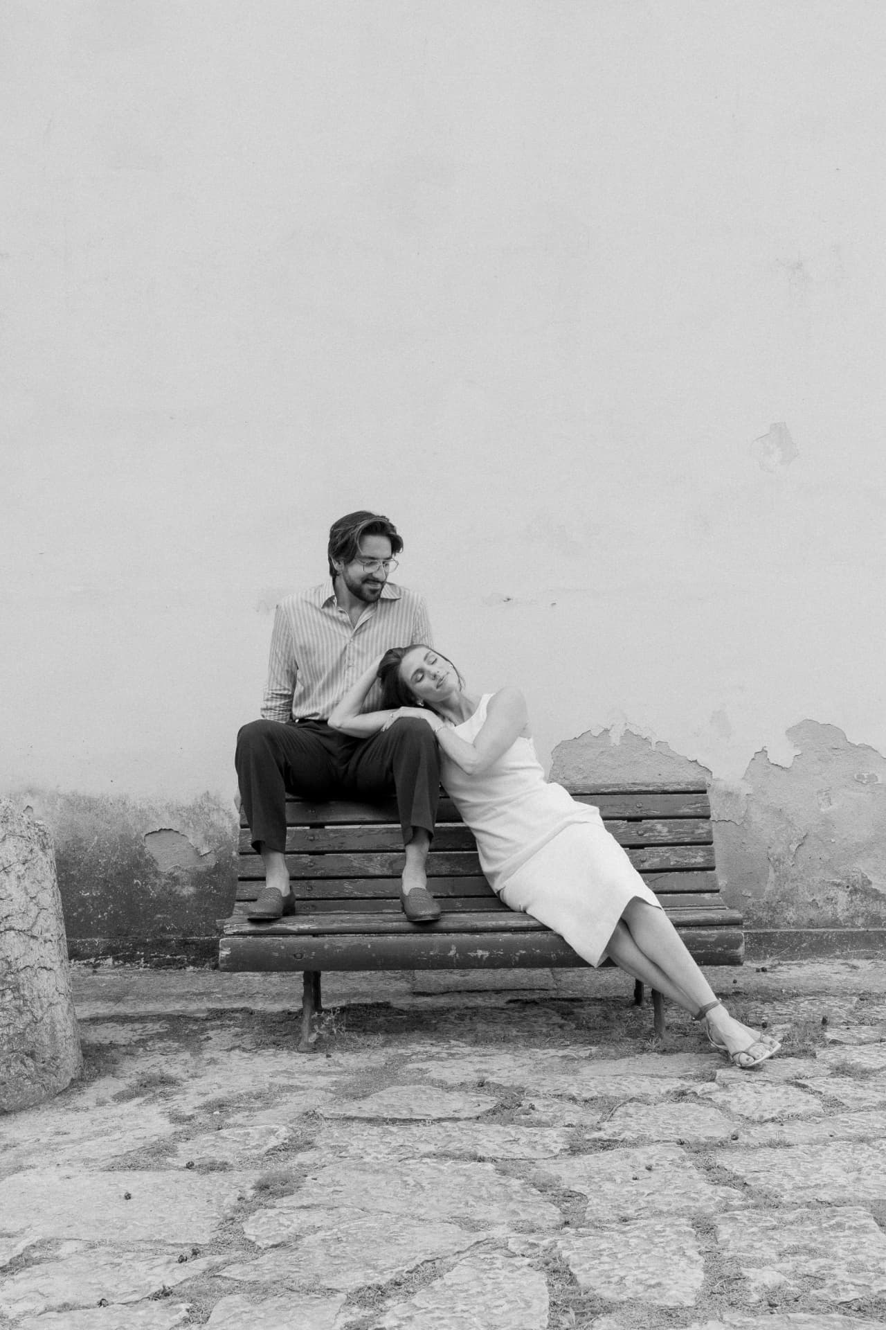 Black and white frame of the couple on a weathered bench