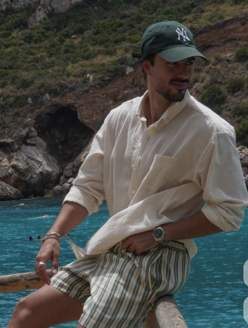 Cream linen shirt with striped shorts on the water